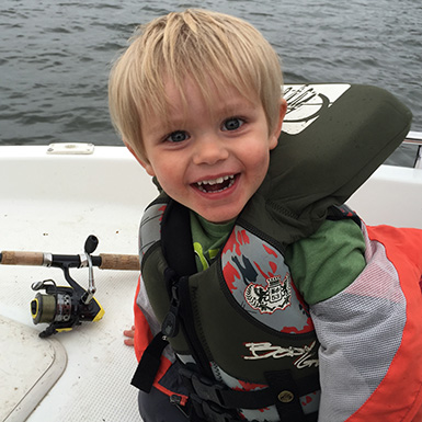 Happy boy fishing in a lake