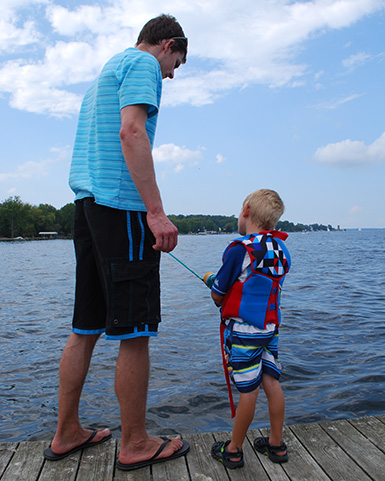 teaching a kid to fish with a push buttom reel
