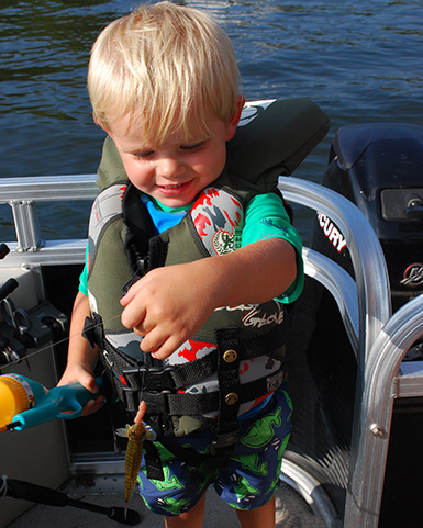 toddler catch fish with push botton pole and a worm