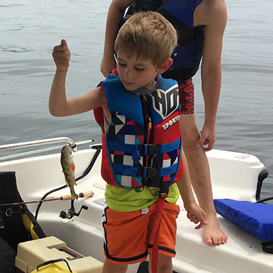young kid catches a perch