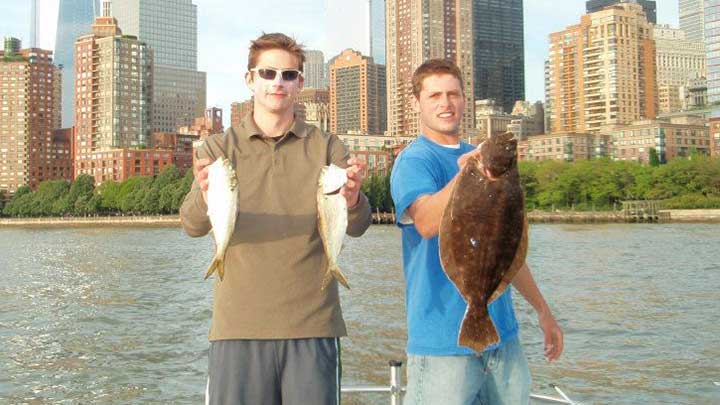 holding a fluke and fluke bait near new york city