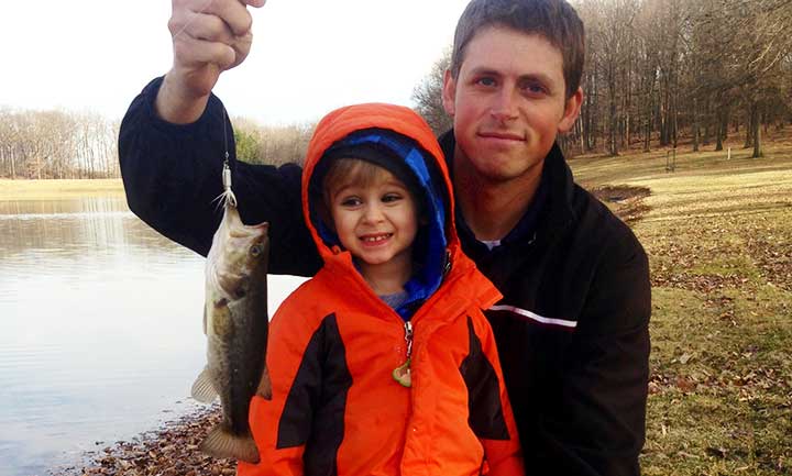 kid catches bass on a roster tail spinner bass lure