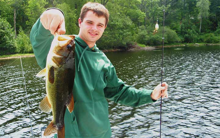 mike with a bass caught on a mepps spinner bass lure