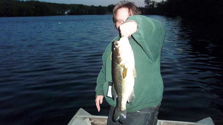 mitch catches a bass on a popper surface lure