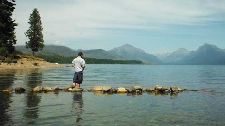 trout fishing for trout in a lake at glacier national park