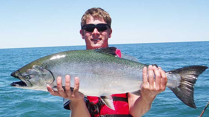 cody with a huge king salmon in lake ontario