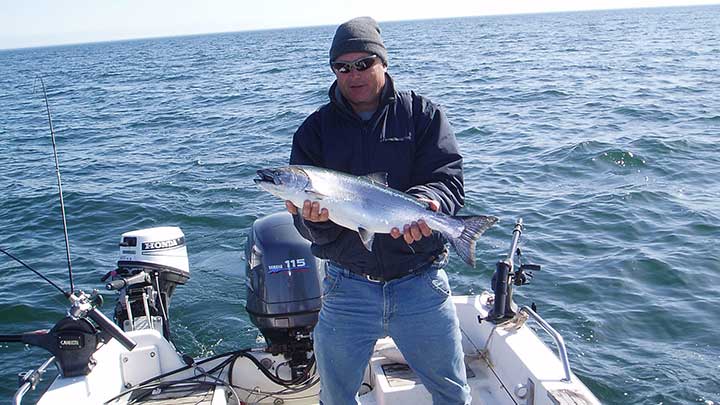 catching fish with manual downriggers on a small boat