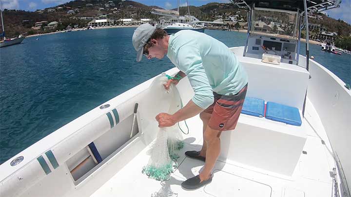 collect about half the cast net by pulling from the front of the net