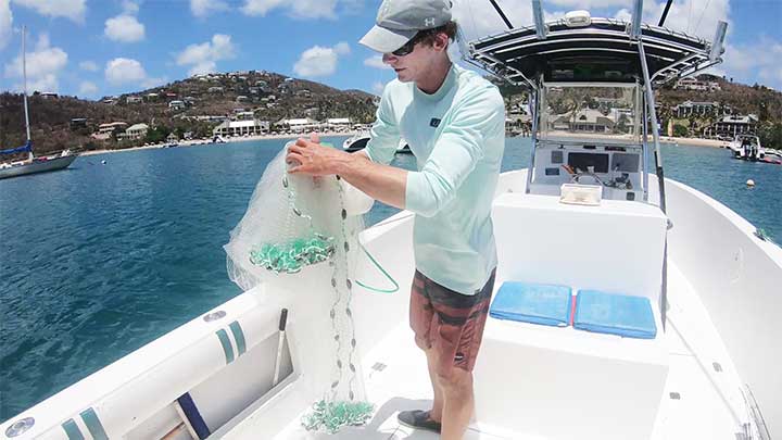 grab the bottom lead line of the cast net and hold it with the right hand
