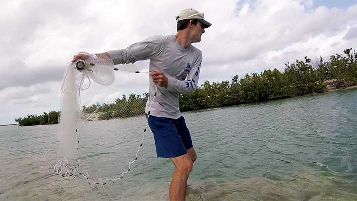 swing the cast net back with both hands
